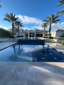 A pool with palm trees in the background