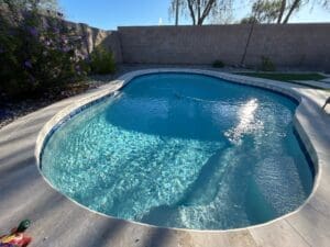 A pool with water coming out of the bottom.